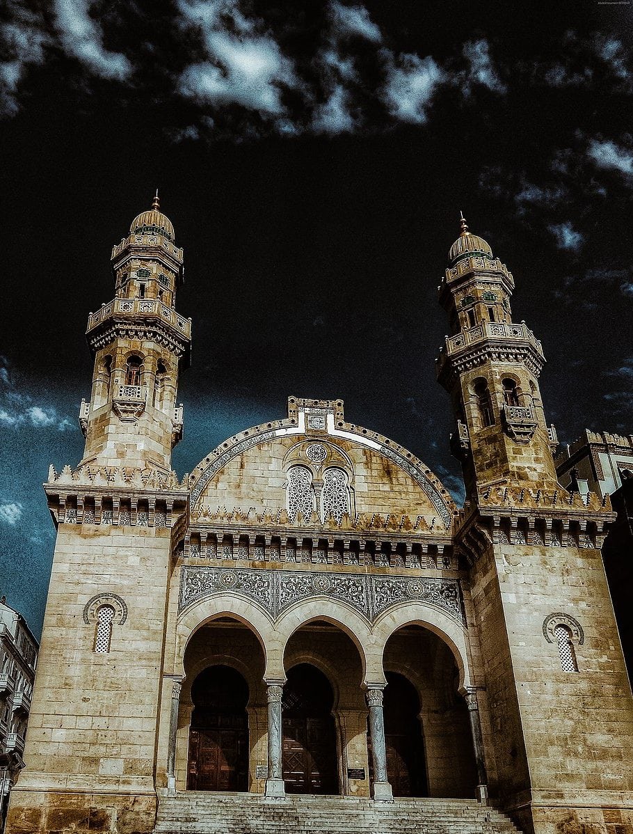Front façade of the Ketchaoua Mosque in Algiers, with arched entrance and twin towers.