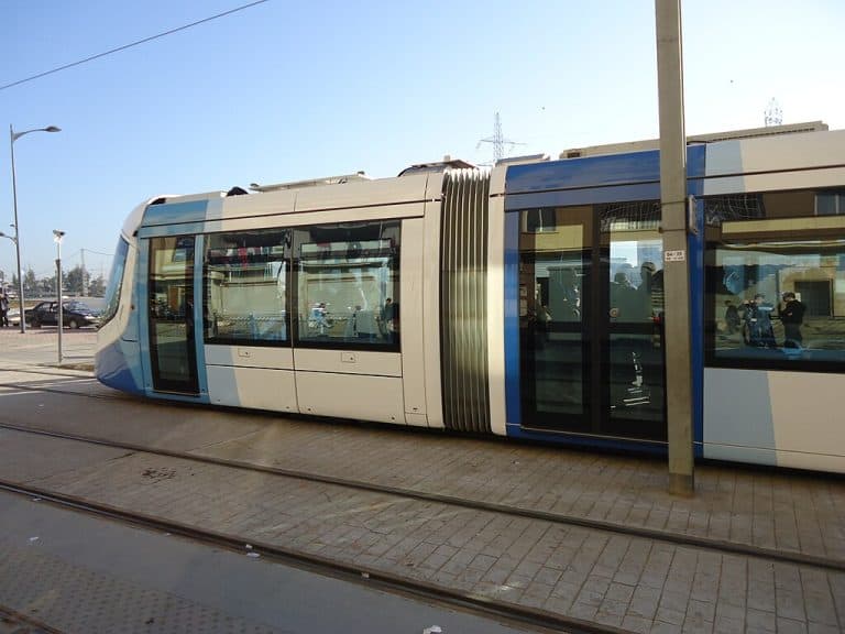 Tram at a platform in Algiers, with tracks in the foreground.
