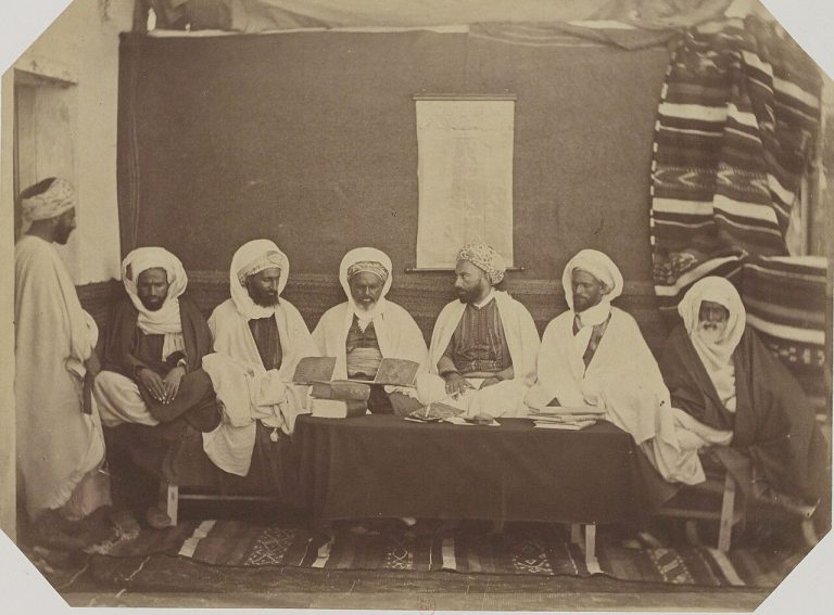 Group portrait of members of the midjelès in Oran, Algeria, photographed in 1856.