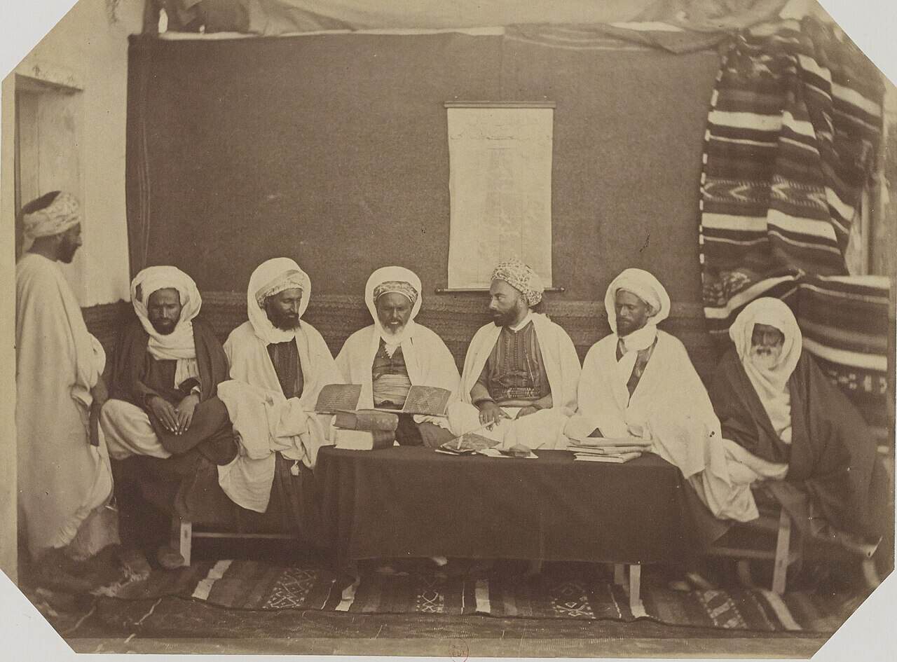 Group portrait of members of the midjelès in Oran, Algeria, photographed in 1856.