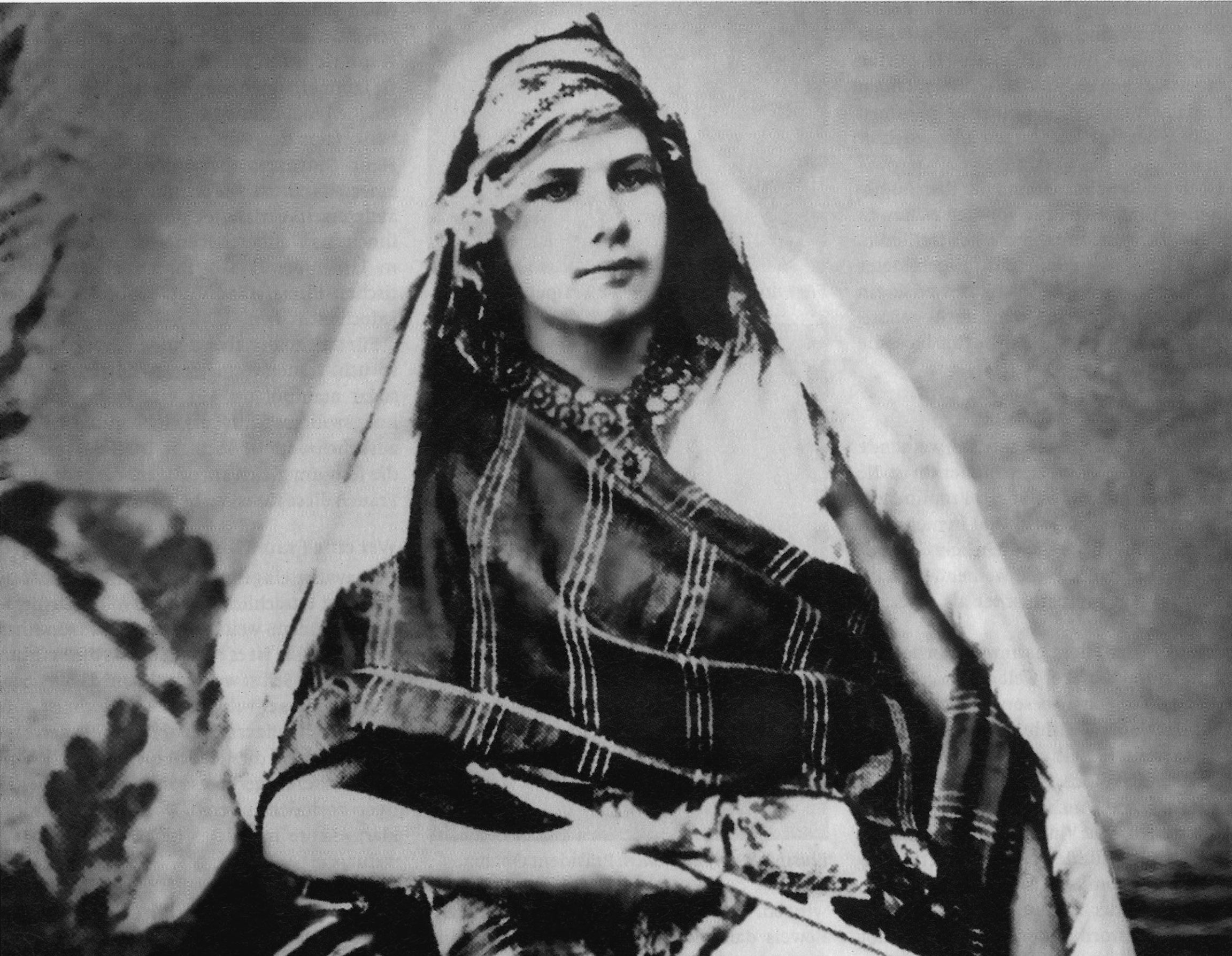 Black-and-white photograph of Isabelle Eberhardt in desert clothing, c. 1900.